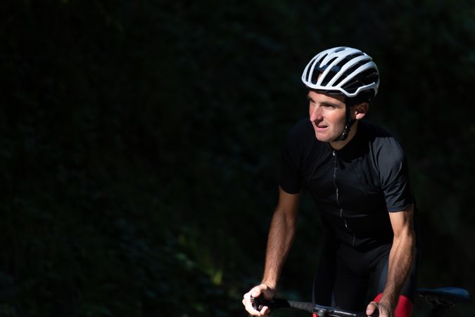 Professional cyclist riding bike in park