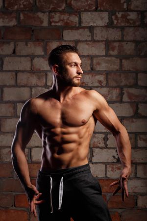 Bodybuilder competitor practicing front poses ahead of competition