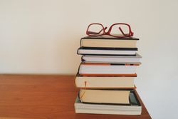 Red framed eyeglasses on books