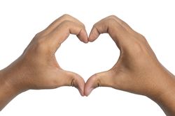 close up of male hands showing heart or love shape gesture
