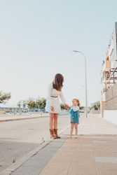 Mother and daughter standing on street