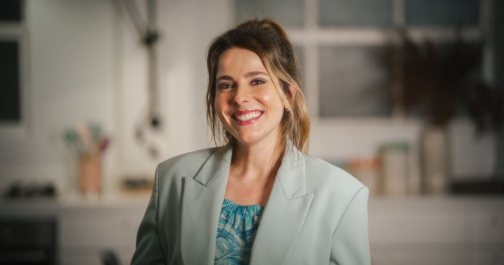 Portrait of Female in Formal Clothes Looking at Camera and Smiling.