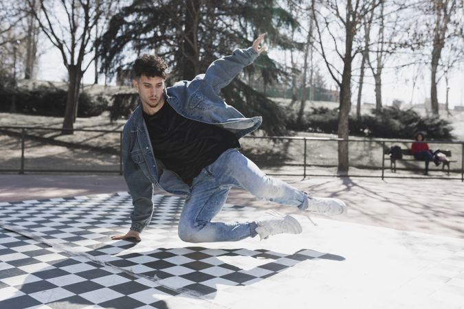 Man dancing break dance in park