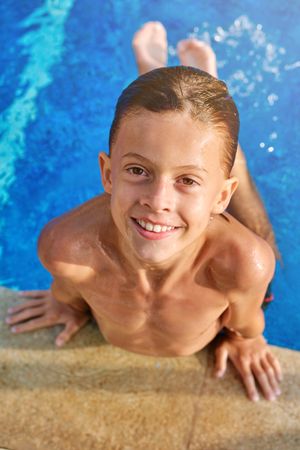 Cheerful boy enjoying vacation in pool