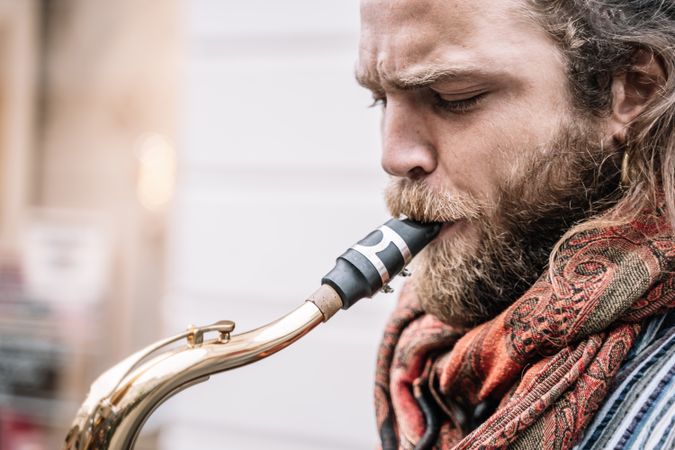 Male saxophonist plays Sax in the street
