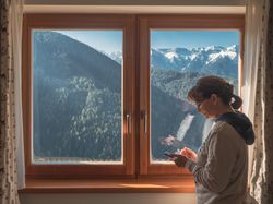 Woman browsing smartphone near window