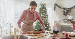 Young Woman Preparing the Dough to Make Gingerbread on Christmas.
