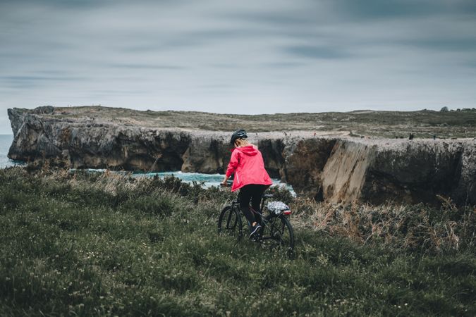Female on bicycle enjoying landscape