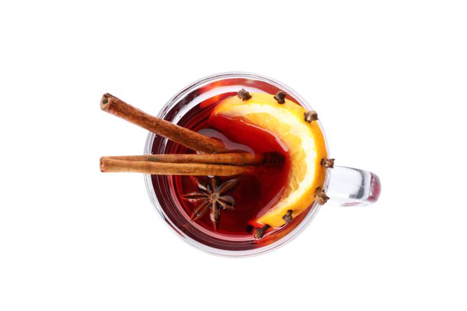 Glass of tasty mulled wine with lemon isolated on blank background