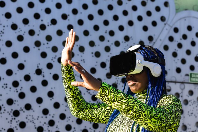 Black woman in VR headset in city