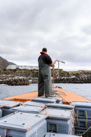 Fisherman on a lobster fishing boat mooring the boat