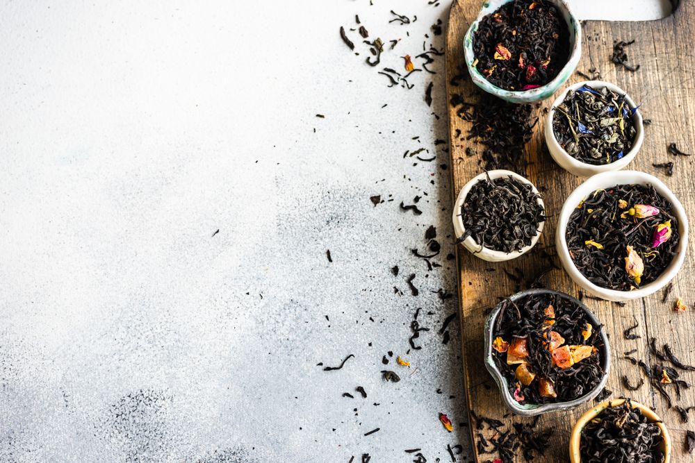 Loose leaf tea varieties on board with copy space