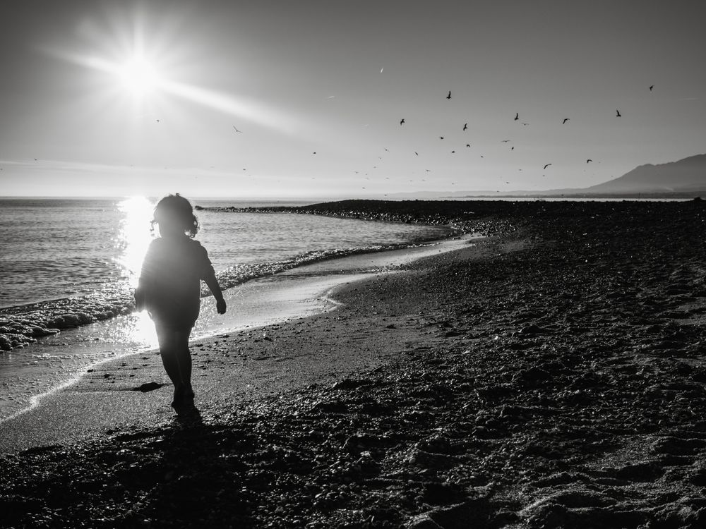 small girl walking by the beach