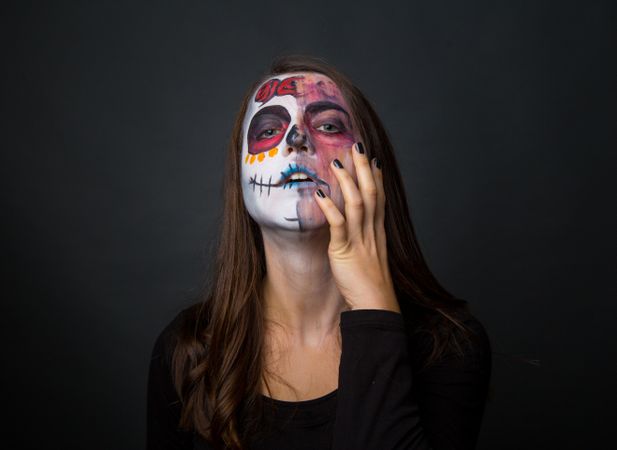 Young woman with creepy face paint