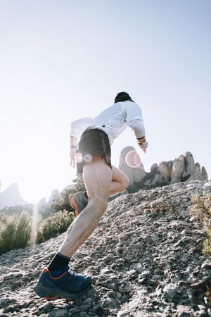 Man running up rocky trail