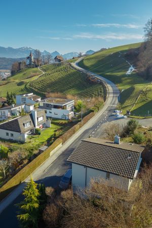 Town on green slope of mountains