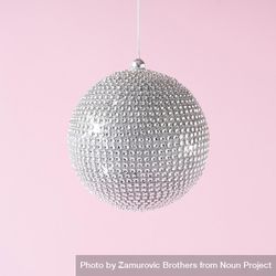 Disco ball Christmas bauble decoration on pastel pink background 0LalA5