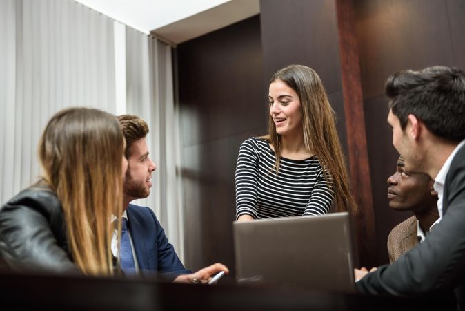 Businesswoman giving a talk to her colleagues at work