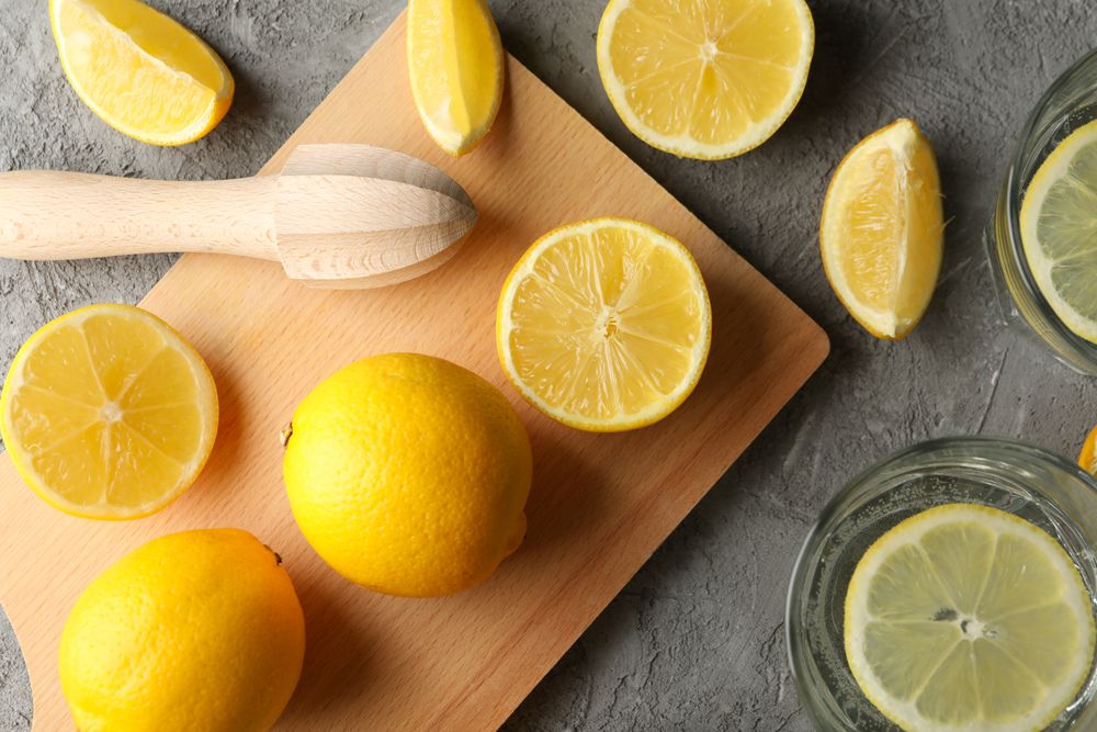 Composition with lemonade and lemons on gray background