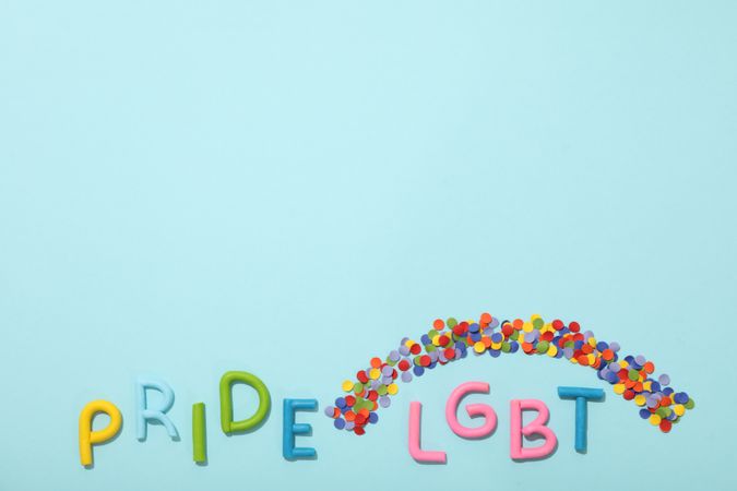 LGBT parade concept, festive colorful symbols on blue background.