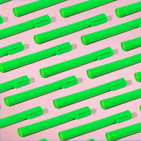 Rows of green highlighter on pink background with shadow