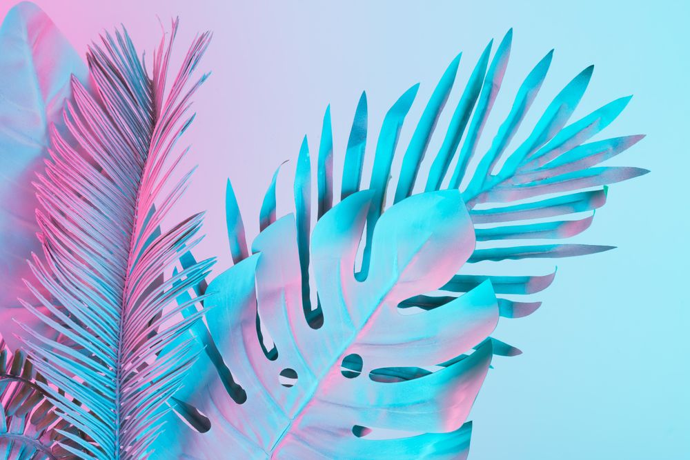 Tropical and palm leaves in vibrant bold gradient holographic colors