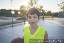 Portrait of a young teen wearing a yellow basketball sleeveless 0JmQvb