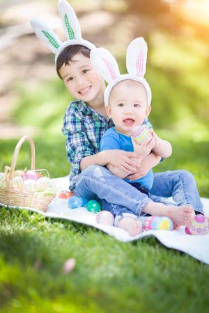 Boys Outside in Park Playing with Easter Eggs