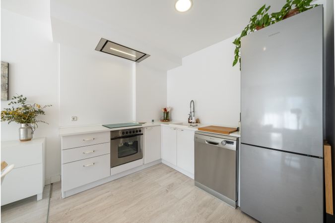 Interior of modern kitchen with furniture and appliances