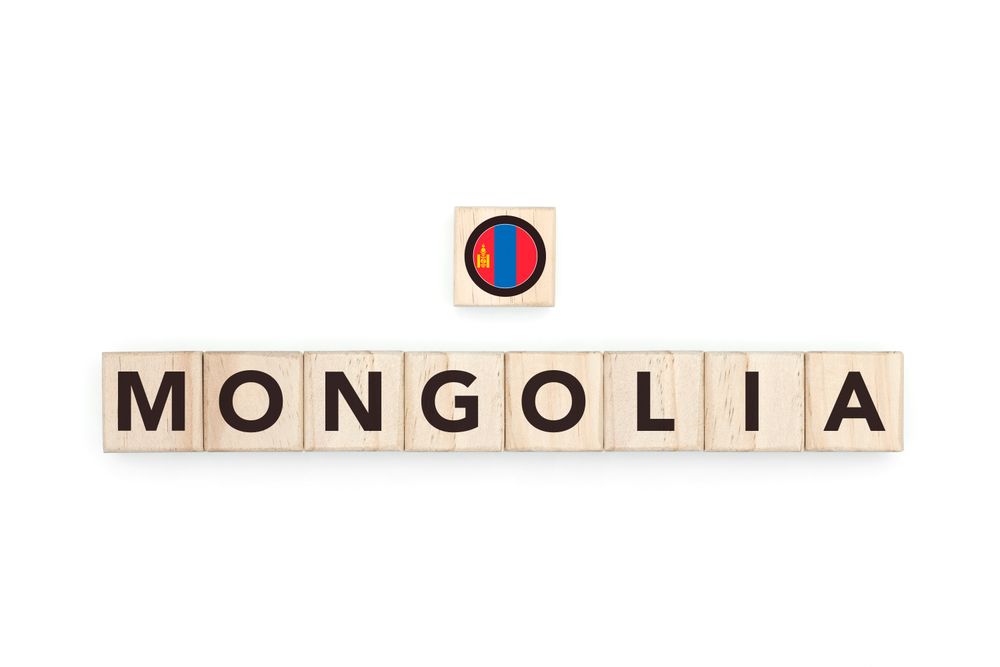 Wooden blocks bearing the name and flag of Mongolia. Mongolian and Asian Culture, national identity, travel, and geography in a copy space design.