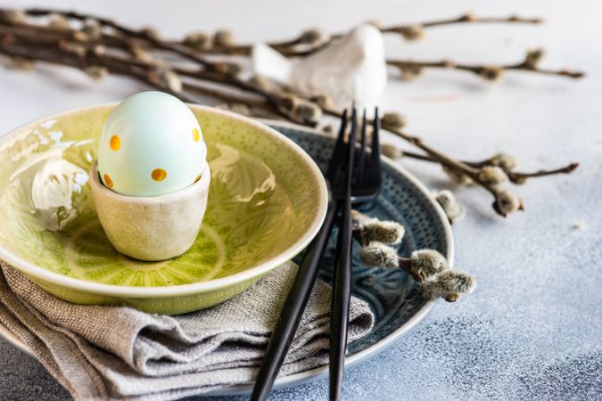 Easter holiday concept with decorative egg in yellow bowl