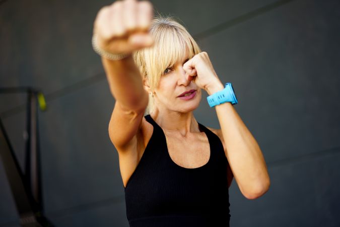 Fit blonde woman punching