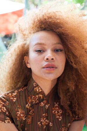 Close up portrait of young Black woman with red hair and freckles