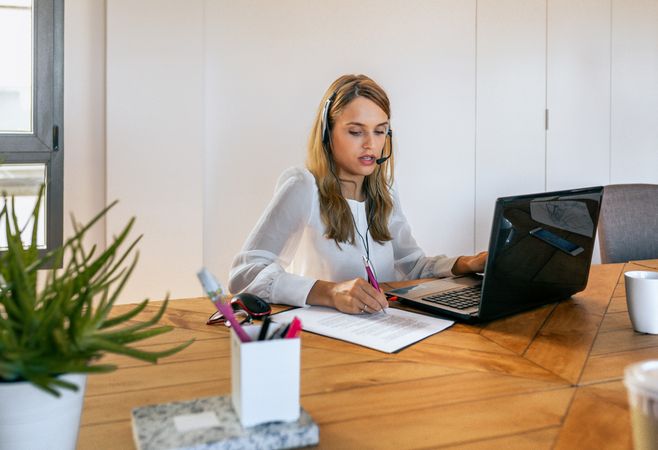 Young woman with headset in customer service of coworking