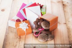 Gifts and envelopes on wooden table 0KOGA0