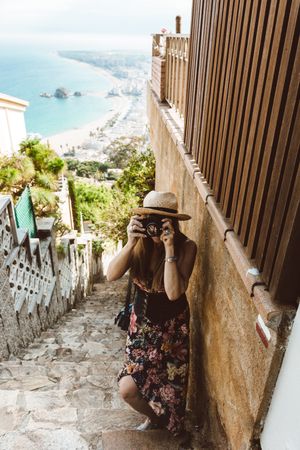 Stylish woman picturing coast from stairway