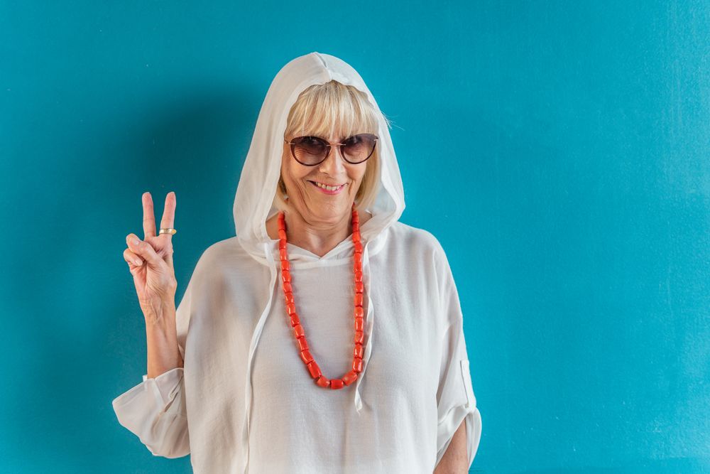 Smiling trendy older female in hood