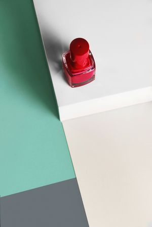 Multi-colored nail polish on pastel colors geometric pattern background
