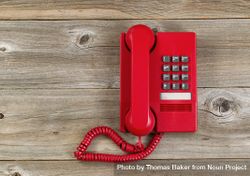 Vintage red phone on rustic wood 4dQNNb