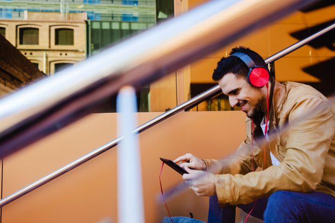 Man using tablet on steps