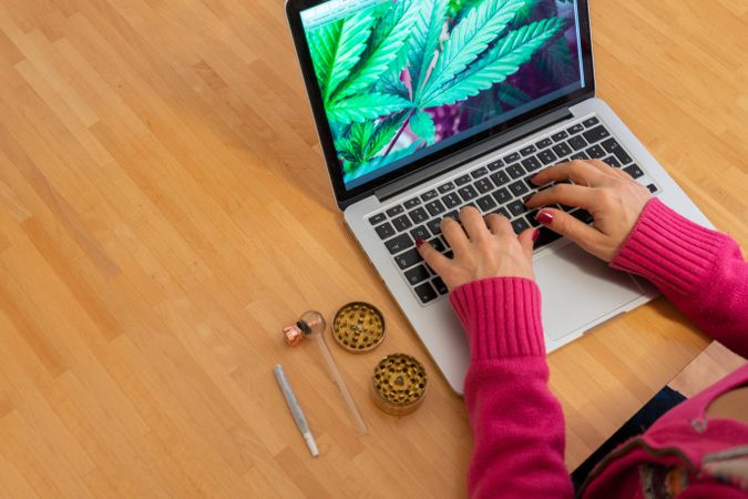 Woman at computer with marijuana leaves
