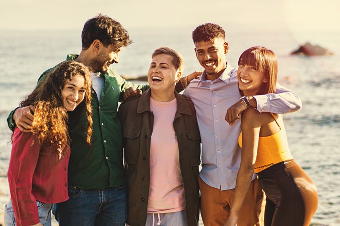 Diverse Friends Embracing and Walking by the Sea