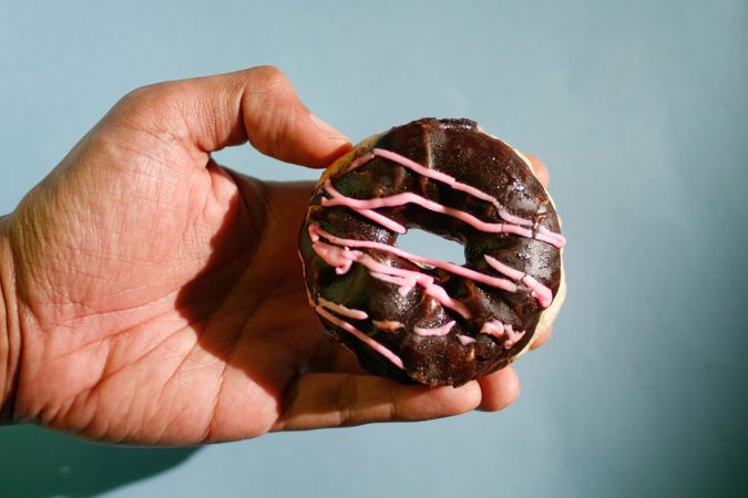 Chocolate donut with pink icing