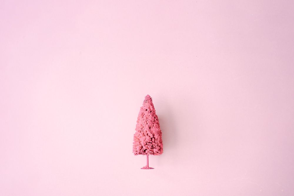 Light pink Christmas tree against pastel background