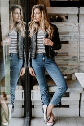 Casual stylish woman standing at table in cafe