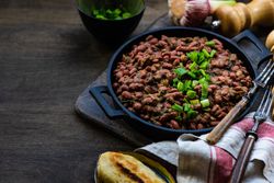 Traditional Georgian lobio dish on wooden table with copy space