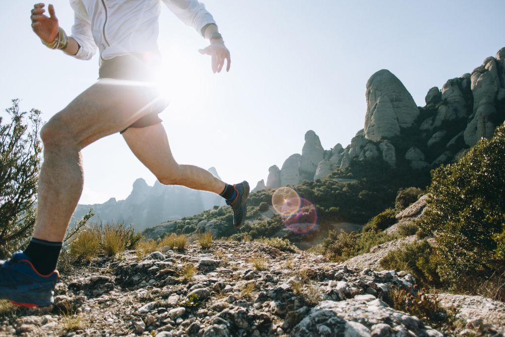 Man training on rugged terrain in the sun