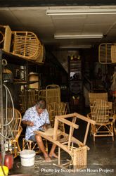 Older man making wooden chairs in a store in George Town, Penang, Malaysia 41vZjb