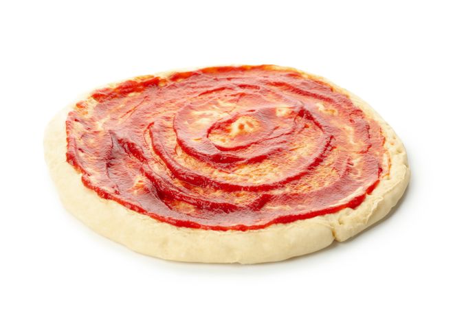Rolled out pizza dough with sauce isolated on blank background