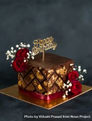 Square chocolate cake with gold leaf, roses and baby’s breath flowers bDDrKb